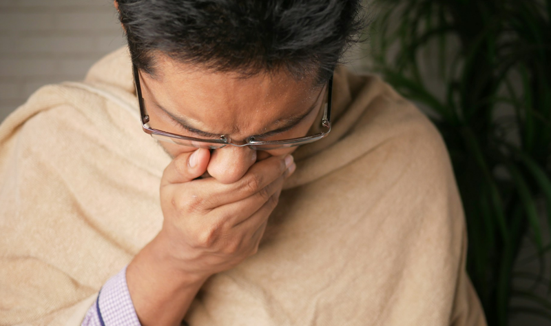 a man coughing